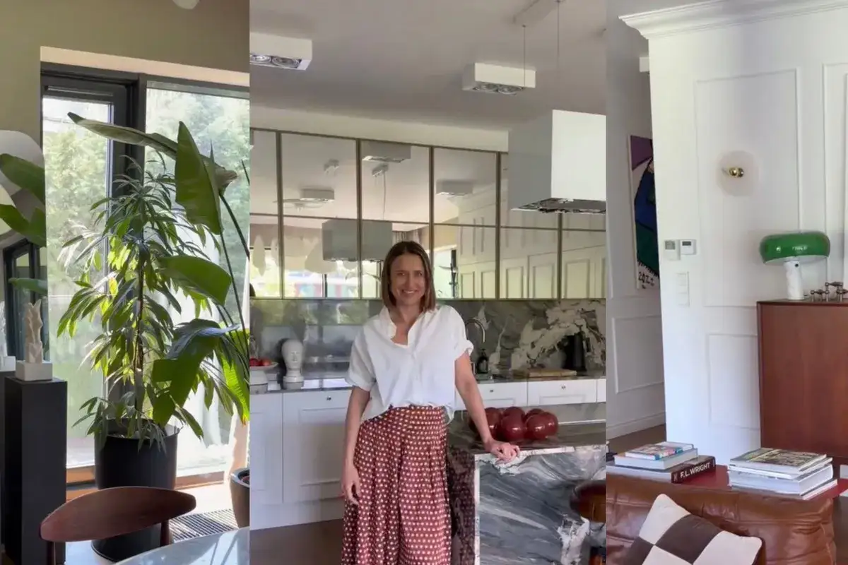 Uśmiechnięta siostra Roberta Lewandowskiego w stylowej kuchni z marmurowym blatem i nowoczesnymi meblami. W tle widać salon z zieloną lampką.